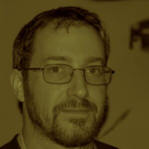 A man wearing glasses and a sweater.
