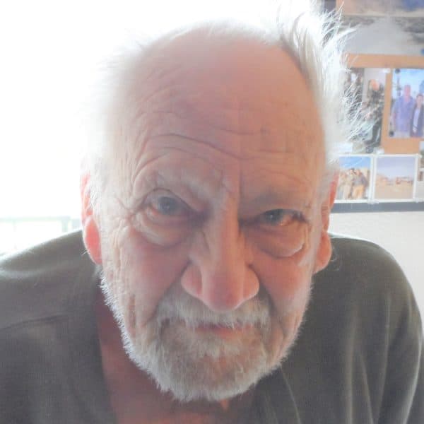 An older man with a beard and a smile.